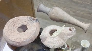 Ancient Rome terracotta comprising a spindle vase and two oil lamps, circa 3rd/4th century AD.