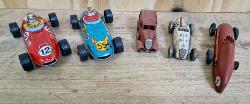 A group of vintage toy cars comprising a German tin Mercedes racing car, a Tri-ang minic red