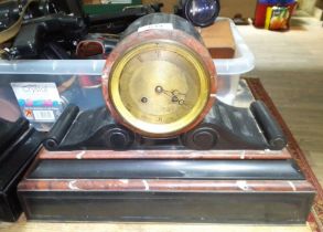 A black slate and marble mantle clock.