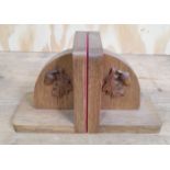 A pair of oak bookends with acorn motif.