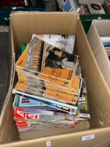 A box of military magazines, mostly relating to WWI and WWII.