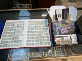 A stamp album and a box of other stamps