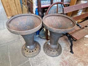 Two large cast iron garden planters.