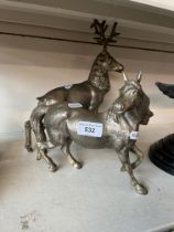 A cast metal stag and a cast metal horse.