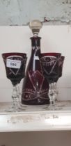 A Bohemian ruby cut glass decanter and glasses.