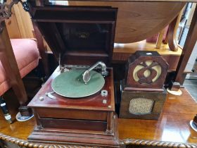 An antique Grafanola table top gramophone with Art Deco carved fish and Handy speakers.
