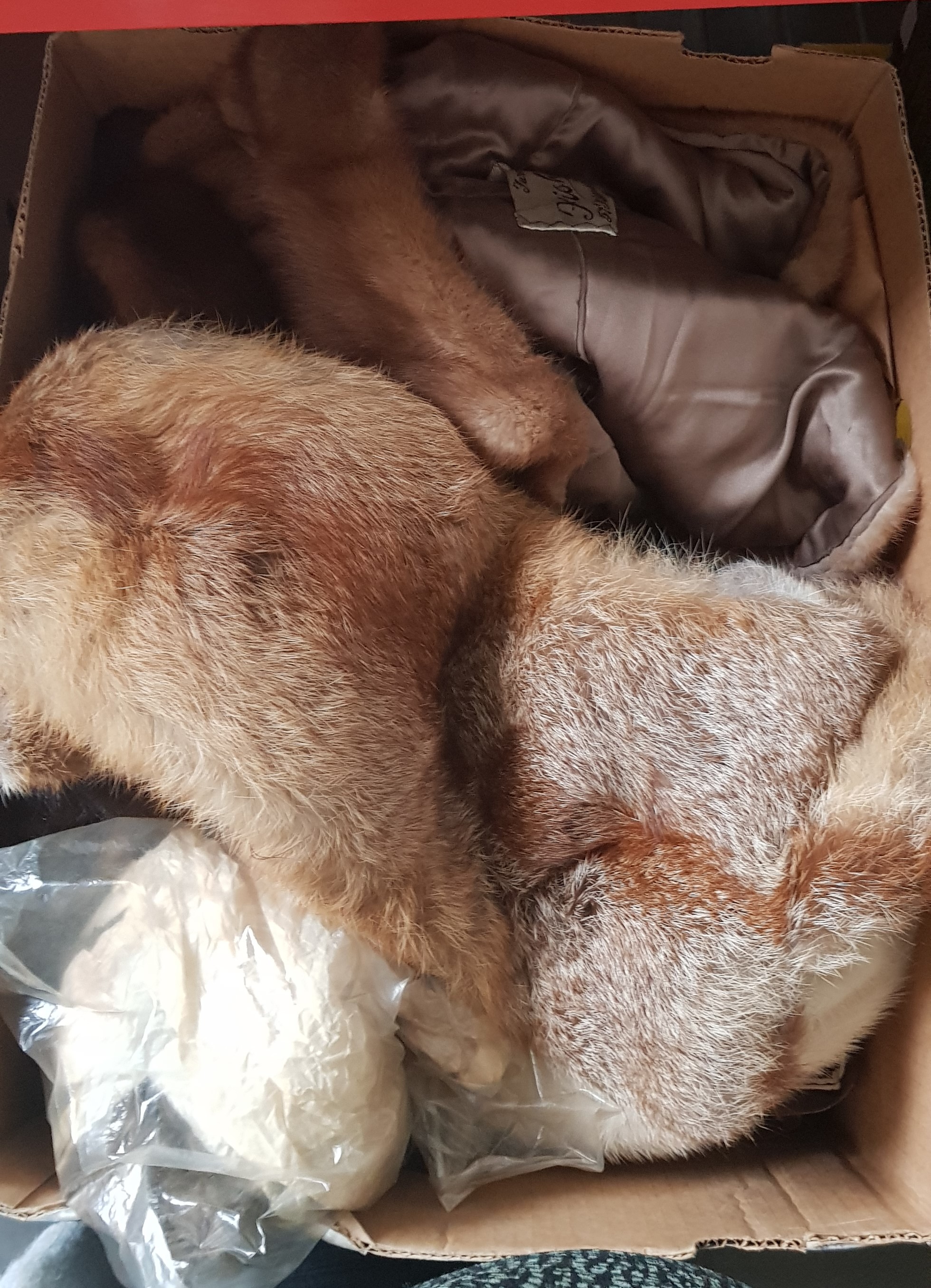 A box containing fur accessories - stole, hats muffs etc