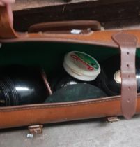 A set of crown green bowls with jack, in leather case