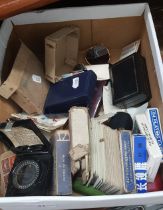 A box containing a magnetic compass, sunglasses, various playing cards, Magnet magnifying bakelite