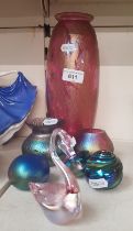 A collection of iridescent art glass including Ditchfield Glasform, Isle of Wight, paperweights,