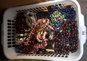 A basket of costume jewellery including bead necklaces, etc.