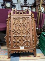 A Gothic carved oak corner cabinet, early 20th century.