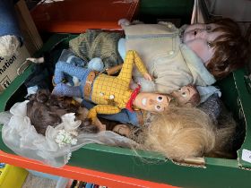 A box of dolls including Woody from Toy Story