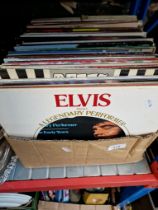 A box of vinyl LP records, various artists and albums.