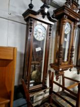 A walnut and ebonised cased Vienna wall clock complete with weights, pendulum and key.