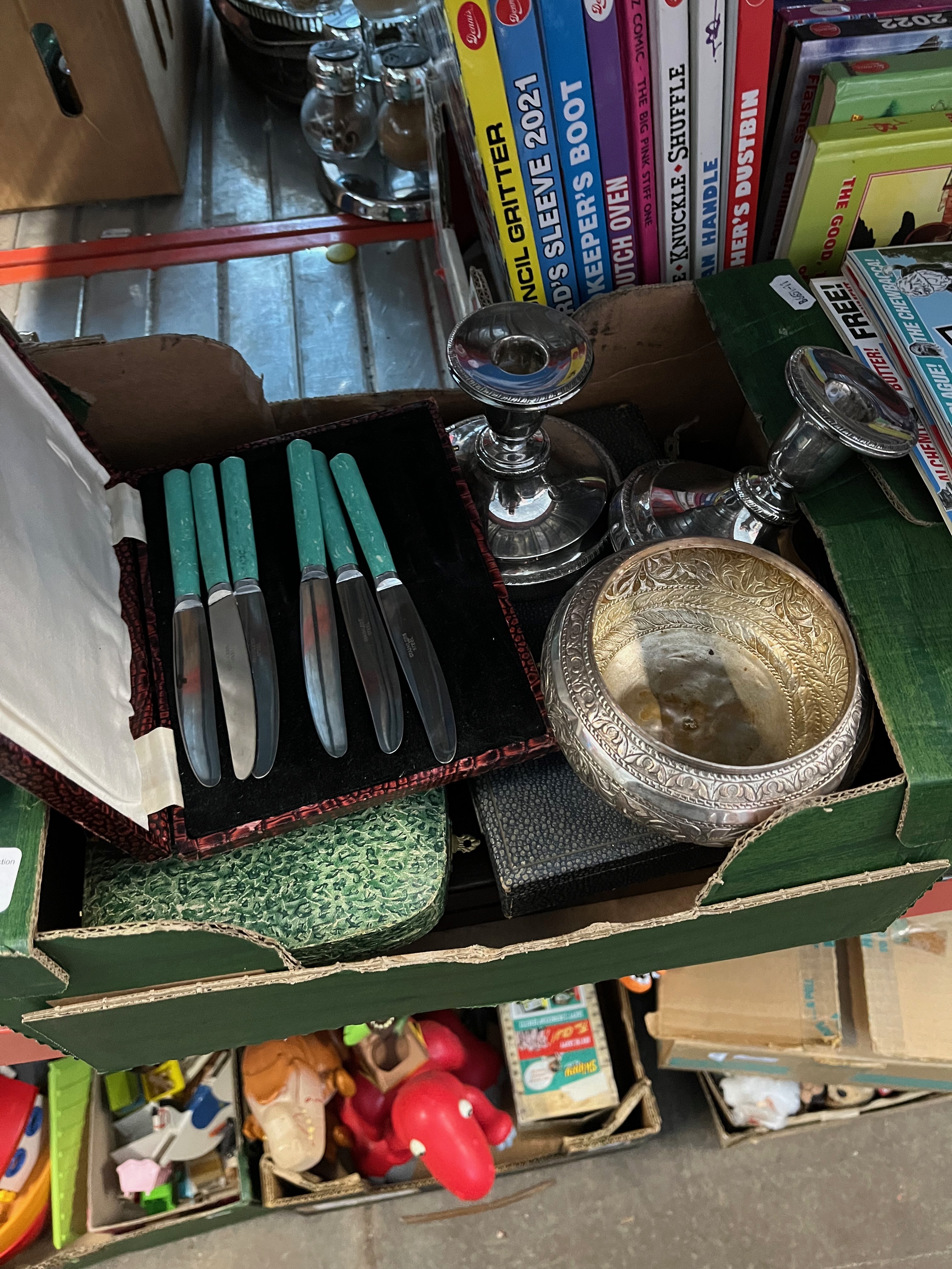 A box of silver plated items and boxed cutlery sets.