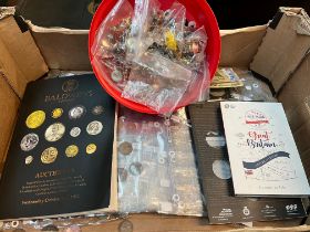 A box of world coins and banknotes and buttons
