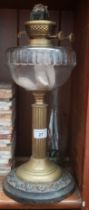 A brass column stem oil lamp with glass bowl and funnel