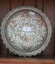 An Islamic bronze and white metal dish.