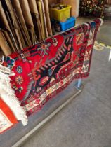 A vintage Eastern hand knotted wool carpet, red ground, 203cm x 133cm appx