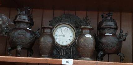 Five pieces of Japanese bronze comprising a pair of vases, a pair of lidded vases and a clock.