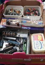 A box of toys including plastic figures, animals, model railway engines, cribbage set, and a box