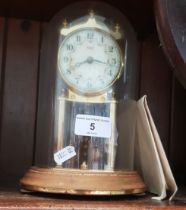 A Kundo 400 day clock with glass dome and key