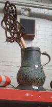 An engraved metal jug containing 2 carpet beaters, 2 leather suitcases and a vintage magazine rack