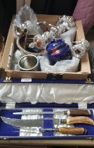 A box of assorted metal ware including a candelabra, silver plated ware, horn handled carving set