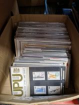 A box of stamp presentation packs, approximately 115.