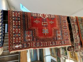 A Middle Eastern silk carpet, red ground, 136cm x 105cm.