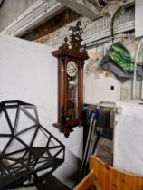 A Vienna wall clock complete with weights, pendulum and key.