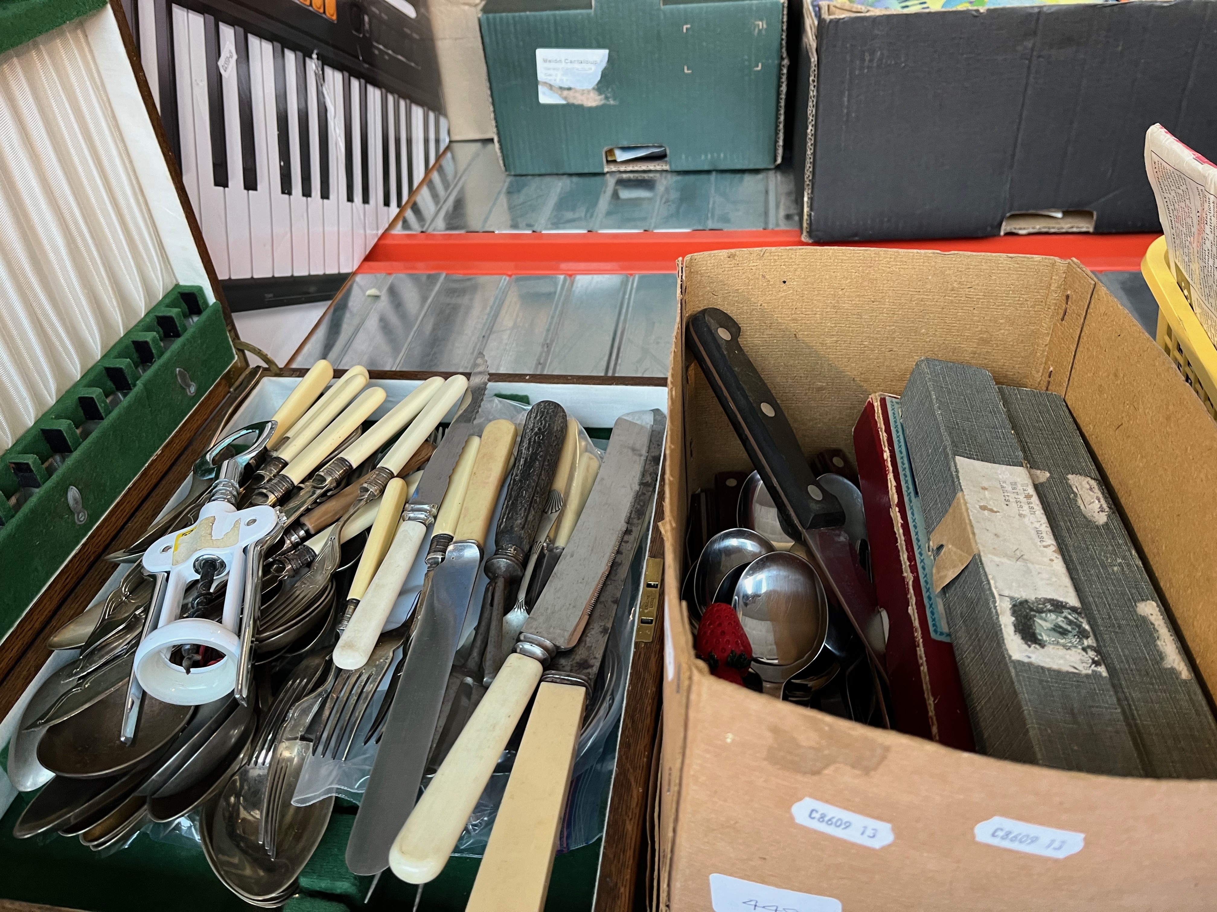 A canteen and a box of silver plated cutlery.