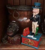 A mixed lot of metal ware comprising two novelty cast metal money banks and a copper bucket.