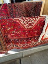 An Iranian hand knotted wool carpet, red ground. Appx 210cm x 168cm