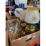 Three brass oil lamps, three small oil lamps, spare oil lamp chimneys etc.