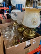 Three brass oil lamps, three small oil lamps, spare oil lamp chimneys etc.
