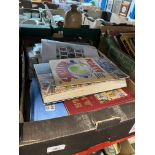 A box of assorted stamps and stamp albums