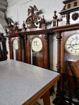 A Vienna wall clock complete with weights, pendulum and key.