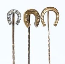 A diamond horse shoe stick pin and two others, gross weight 3.3g.