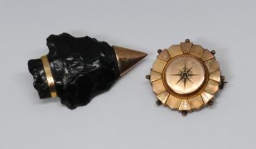 A flint arrow head brooch and a single stone diamond brooch, both marked '9ct'.