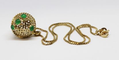 An open work spherical pendant set with green cabochons, marked '585', length (including bale) 25mm,