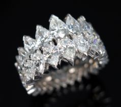 A diamond eternity ring, formed from a double row of diamonds comprising eighteen pear cut