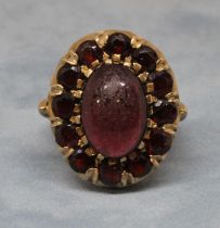 A garnet cluster ring, the oval cluster measuring approx. 23mm x 19mm, marked '9c', gross weight 8.