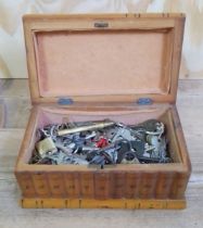 An olive wood puzle box containing keys.