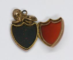 A yellow metal bloodstone and chalcedony shield shaped locket with lion, length 33mm, gross weight