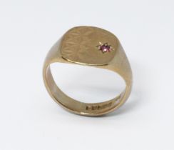 A hallmarked 9ct gold signet ring set with a ruby, gross weight 5.4g, size M.