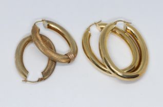 Two pairs of tubular oval earrings, 9ct gold international convention marks, lengths 40mm & 45mm,