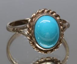 A turquoise cabochon ring, rope twist border, marked '9ct', gross wt. 2.6g, size P.
