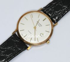 A 9ct gold Record Deluxe wristwatch, case diameter 34mm, leather strap.